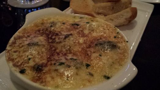 herb escargot covered in baked cheese